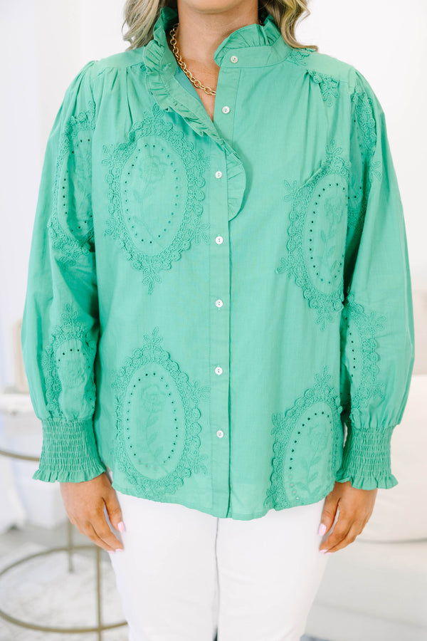 Plus size kelly green button-down top with tonal embroidery, ruffle collar, and smocked cuffs.