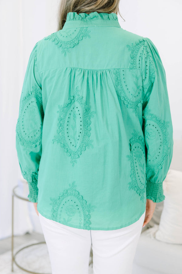 Plus size kelly green button-down top with tonal embroidery, ruffle collar, and smocked cuffs.