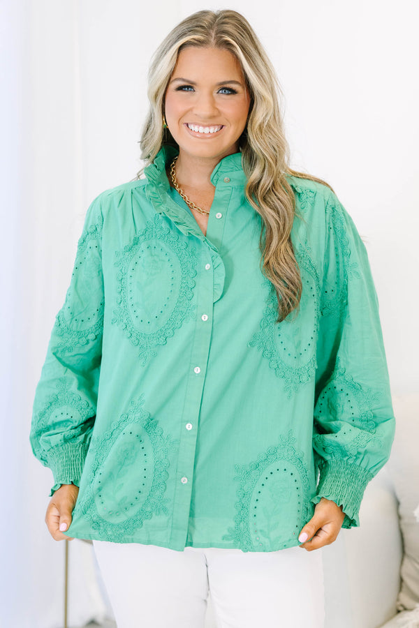 Plus size kelly green button-down top with tonal embroidery, ruffle collar, and smocked cuffs.