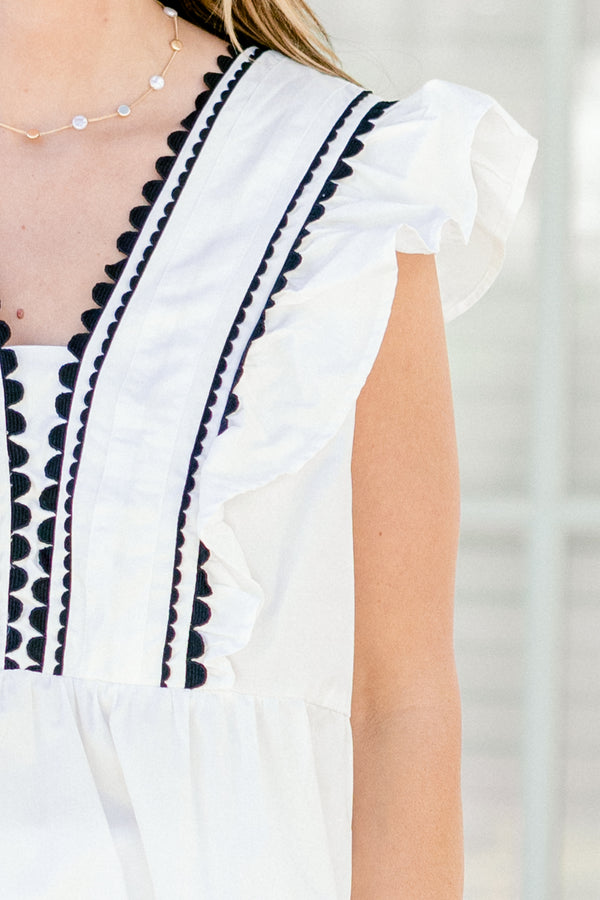 Chic Soul plus size clothing, white sleeveless peplum top with black scallop detailing going down the center of the chest and ruffle accents on the shoulders 