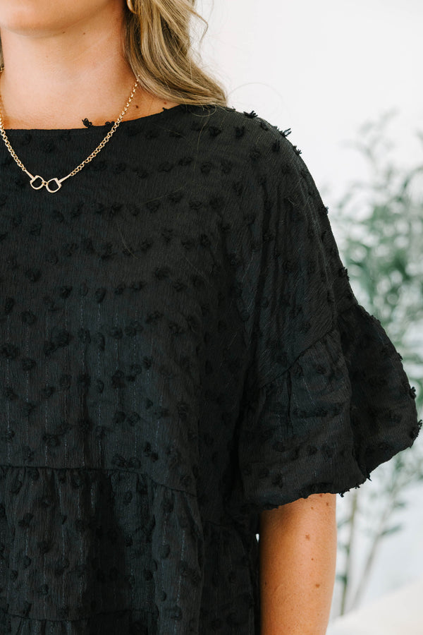 Plus size black textured Swiss dot top with a flowy tiered silhouette and ruffle sleeves.