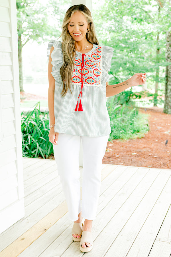 Chic Soul plus size clothing, light sage and white vertically striped flutter sleeve top with red tassel string tie at neckline and embroidered abstract red and blue pattern on upper front