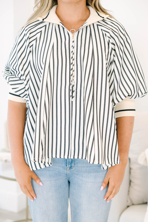Plus size black and white striped top with a flowy fit, quarter-zip neckline, and ribbed cuffs.