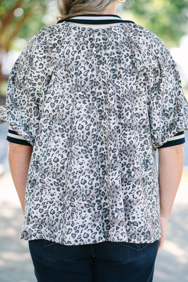 Plus Size leopard print quarter-zip top with short sleeves and a relaxed fit.