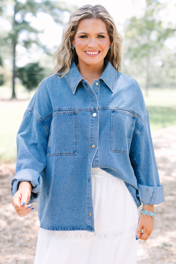 Plus size denim jacket with a relaxed fit, button-down front, and chest pockets.