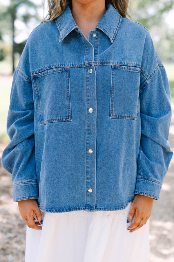 Plus size denim jacket with a relaxed fit, button-down front, and chest pockets.