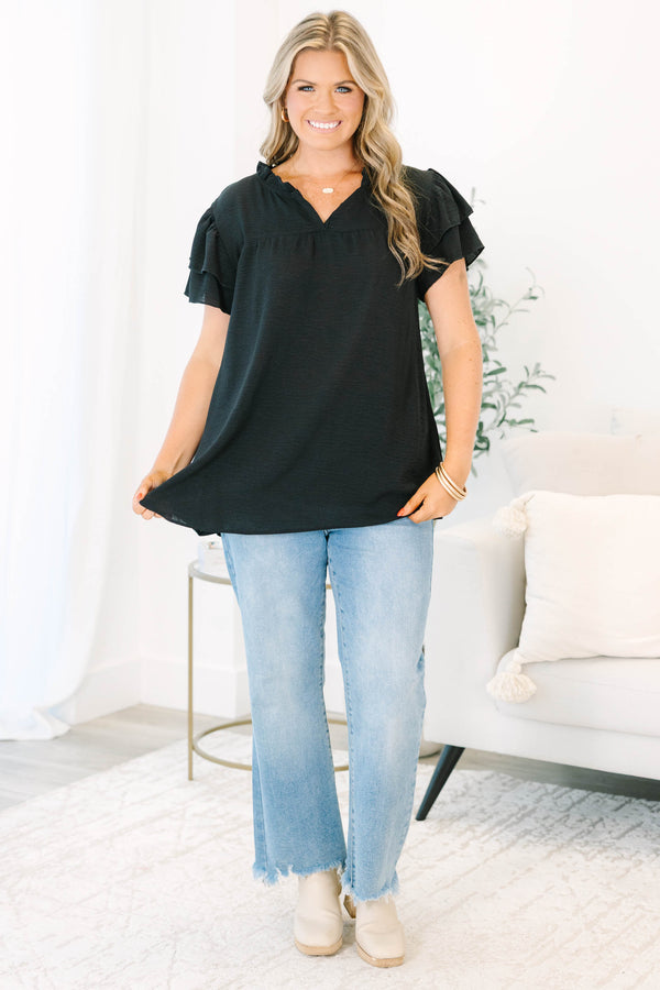 Plus Size black short sleeve top with tiered ruffle sleeves, a v-neckline, and a relaxed fit.