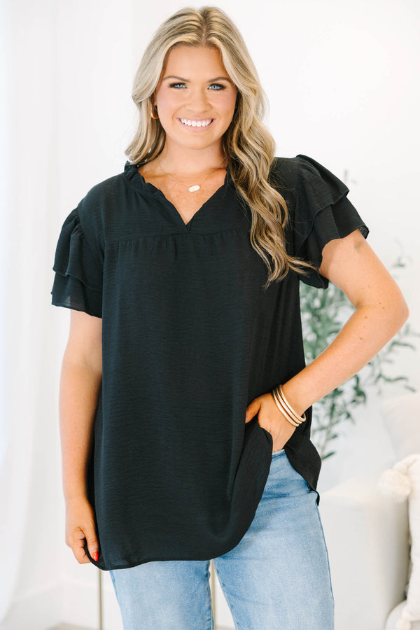 Plus Size black short sleeve top with tiered ruffle sleeves, a v-neckline, and a relaxed fit.