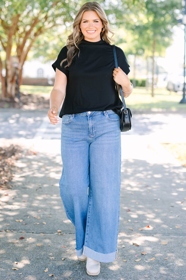 Plus Size medium wash wide leg jeans with a high waist and raw-edge cuffed hems.