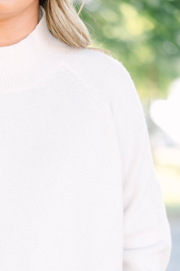 Plus size beige oversized mock neck sweater with a cozy, relaxed fit and ribbed texture.