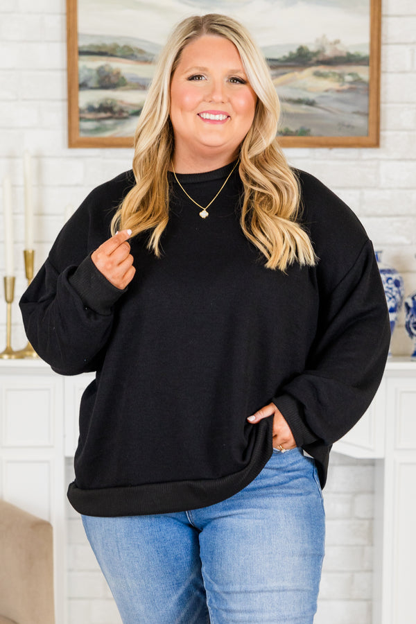 Plus Size black long sleeve top with drop shoulders, ribbed crew neck, cuffs, and banded hem.