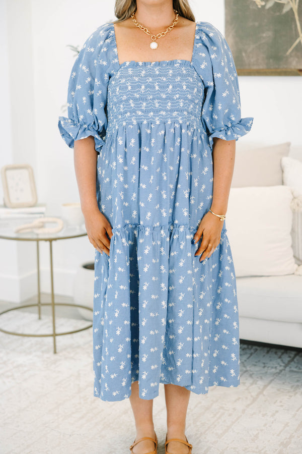 Plus size blue floral midi dress with a smocked bodice, puff sleeves, and a flowy tiered skirt.