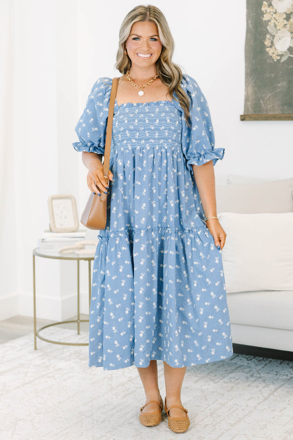 Plus size blue floral midi dress with a smocked bodice, puff sleeves, and a flowy tiered skirt.