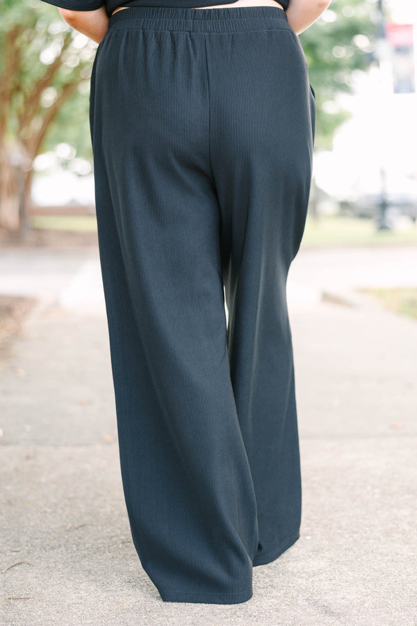 Plus size black ribbed knit lounge set with a boxy short sleeve top and matching pants.