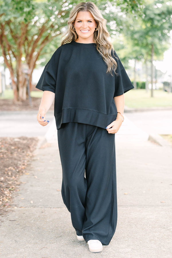 Plus size black ribbed knit lounge set with a boxy short sleeve top and matching pants.