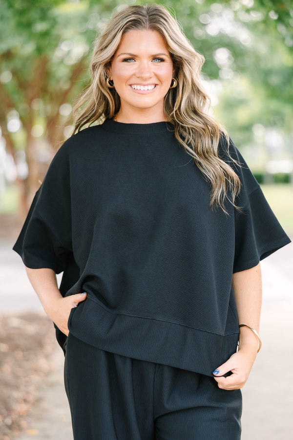 Plus size black ribbed knit lounge set with a boxy short sleeve top and matching pants.