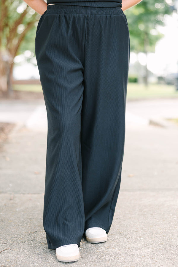 Plus size black ribbed knit lounge set with a boxy short sleeve top and matching pants.