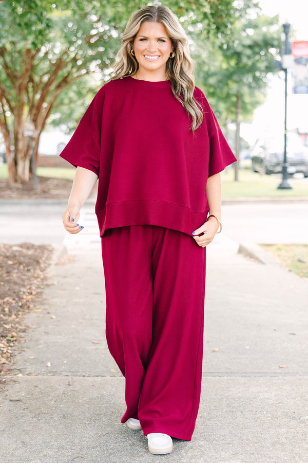 Plus Size red two-piece set with a ribbed short-sleeve crewneck top and matching wide-leg pants.