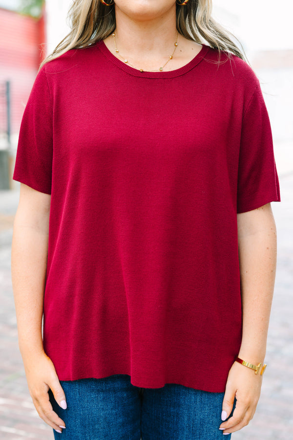 Plus Size burgundy short sleeve knit sweater with a round neckline and relaxed fit.