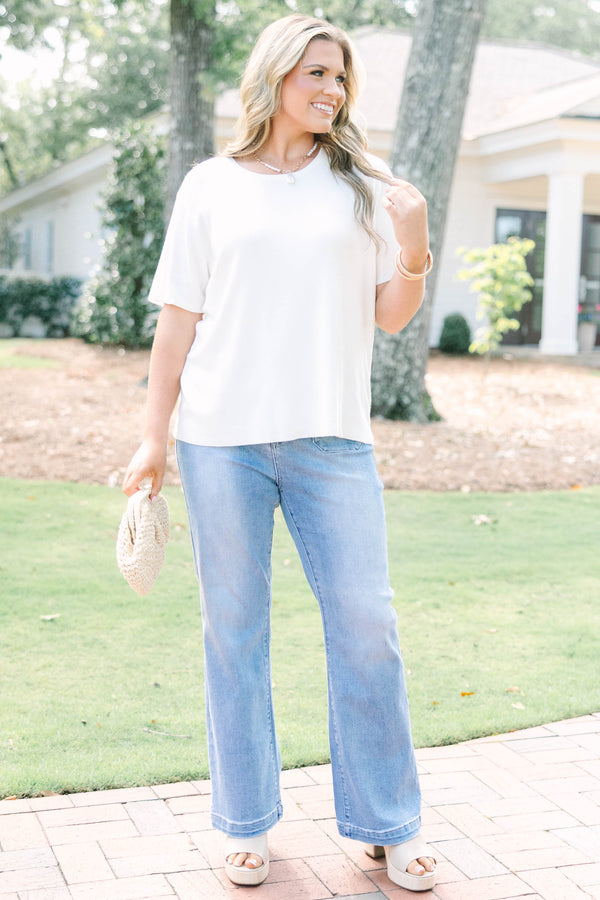 Plus size short sleeve, flowy knit sweater top with a round neck.