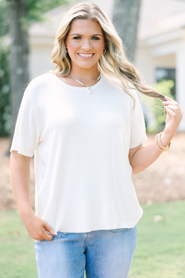 Plus size short sleeve, flowy knit sweater top with a round neck.