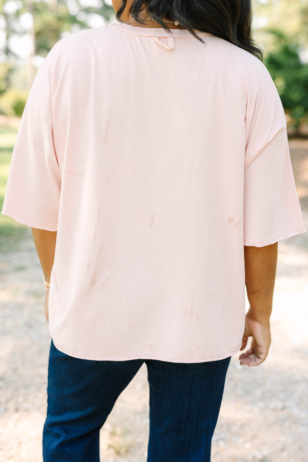 Plus Size blush pink vintage wash tee with an American Cowgirl graphic and unfinished hems.