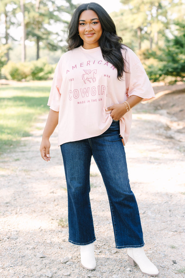 Plus Size blush pink vintage wash tee with an American Cowgirl graphic and unfinished hems.