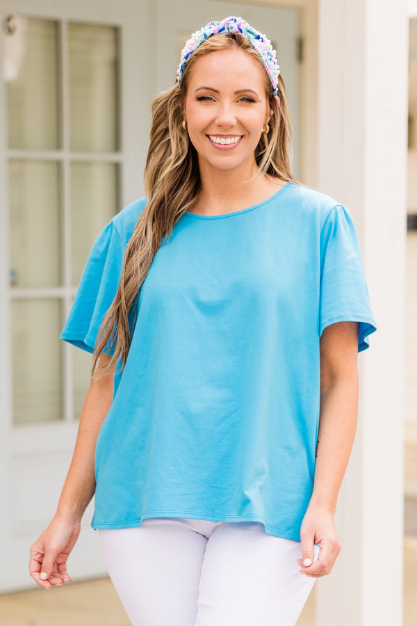 Plus Size turquoise short-sleeve top with a round neckline and relaxed fit.