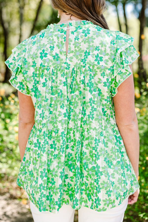 Plus Size green floral print top with flutter sleeves, a high neckline, and a tiered babydoll fit.