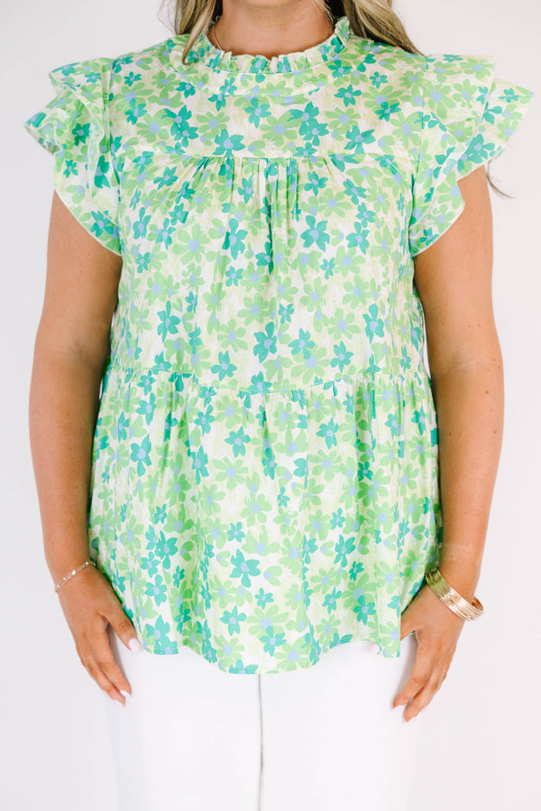 Plus Size green floral print top with flutter sleeves, a high neckline, and a tiered babydoll fit.