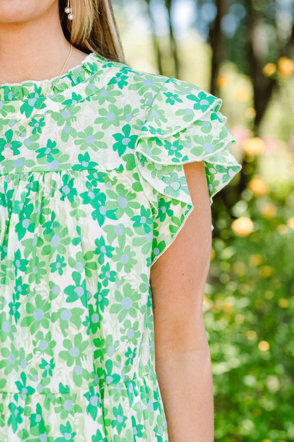 Plus Size green floral print top with flutter sleeves, a high neckline, and a tiered babydoll fit.
