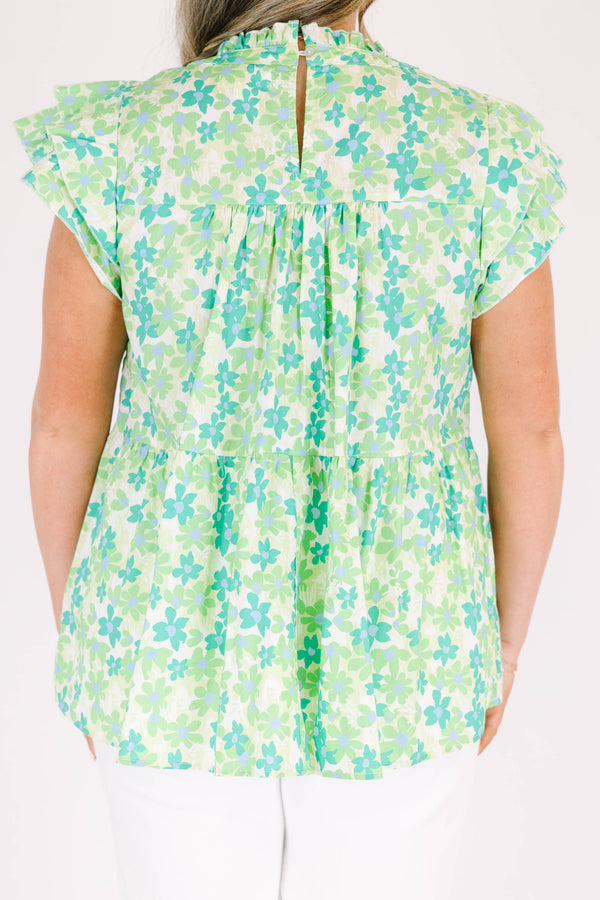 Plus Size green floral print top with flutter sleeves, a high neckline, and a tiered babydoll fit.