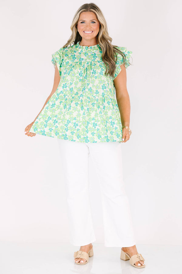 Plus Size green floral print top with flutter sleeves, a high neckline, and a tiered babydoll fit.