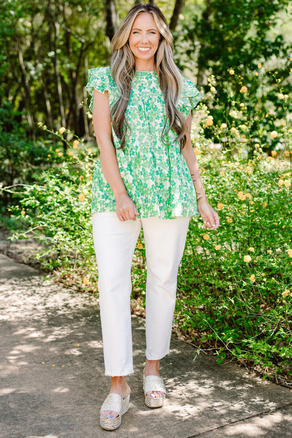 Plus Size green floral print top with flutter sleeves, a high neckline, and a tiered babydoll fit.