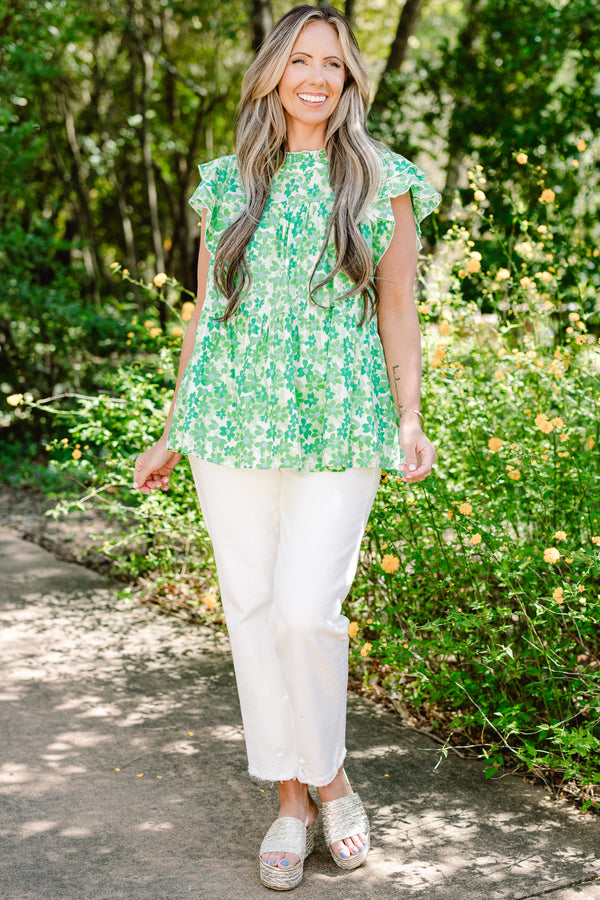 Plus Size green floral print top with flutter sleeves, a high neckline, and a tiered babydoll fit.