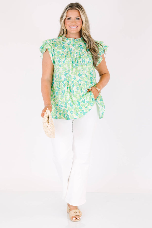 Plus Size green floral print top with flutter sleeves, a high neckline, and a tiered babydoll fit.