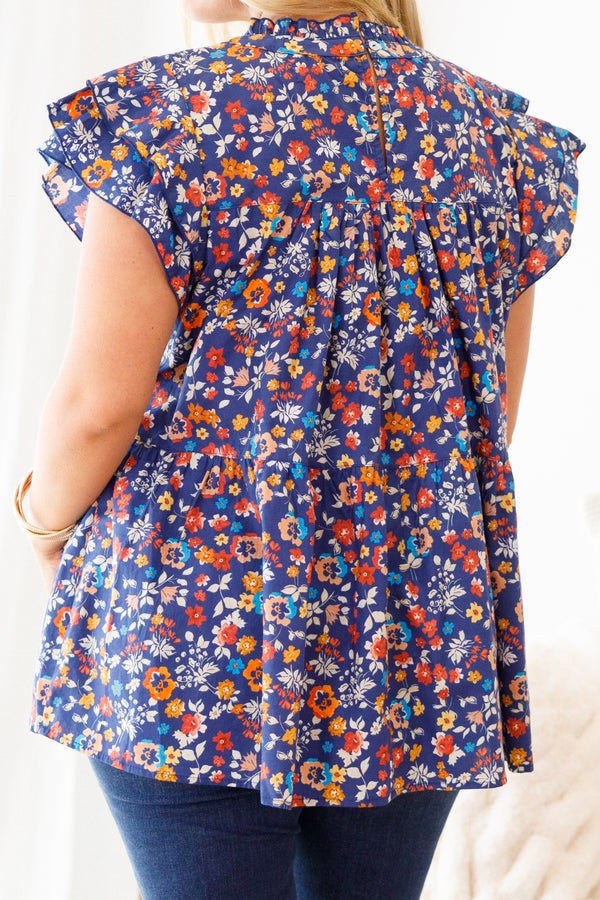Chic Soul Plus size clothing, navy blue baby doll top with a multi-color floral pattern and flutter sleeves 

