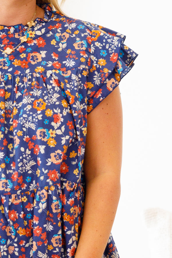 Chic Soul Plus size clothing, navy blue baby doll top with a multi-color floral pattern and flutter sleeves 

