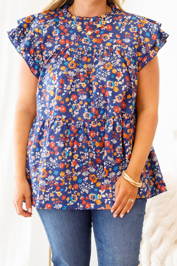 Chic Soul Plus size clothing, navy blue baby doll top with a multi-color floral pattern and flutter sleeves 

