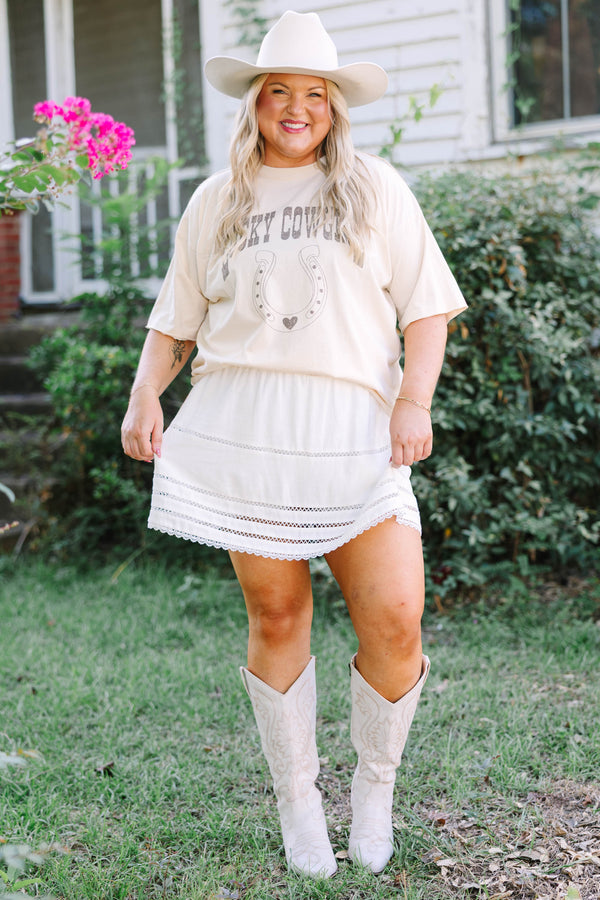 Plus Size sand vintage wash tee with a horseshoe graphic and a white eyelet mini skirt.