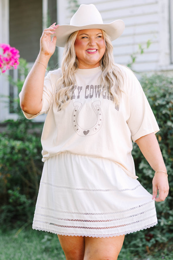 Plus Size sand vintage wash tee with a horseshoe graphic and a white eyelet mini skirt.
