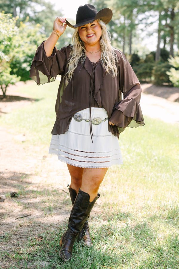 Plus Size brown long sleeve top with ruffle trim, lace-up neckline, and tiered bell sleeves.