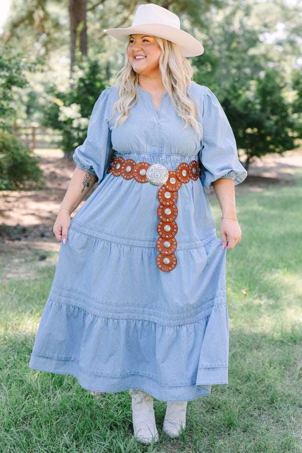 Plus Size blue denim tiered maxi dress with puff sleeves, a v-neckline, and a brown concho belt.
