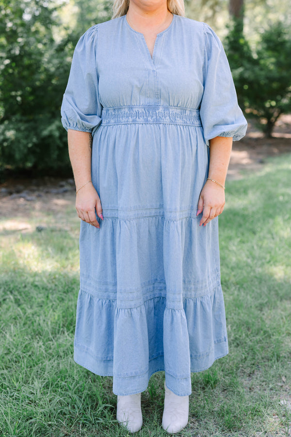 Plus Size blue denim tiered maxi dress with puff sleeves, a v-neckline, and a brown concho belt.