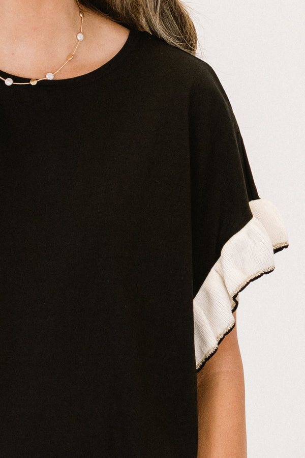 Chic Soul Plus size clothing, black casual top with white flutter sleeves and black stitching detail at the end of each sleeve 

