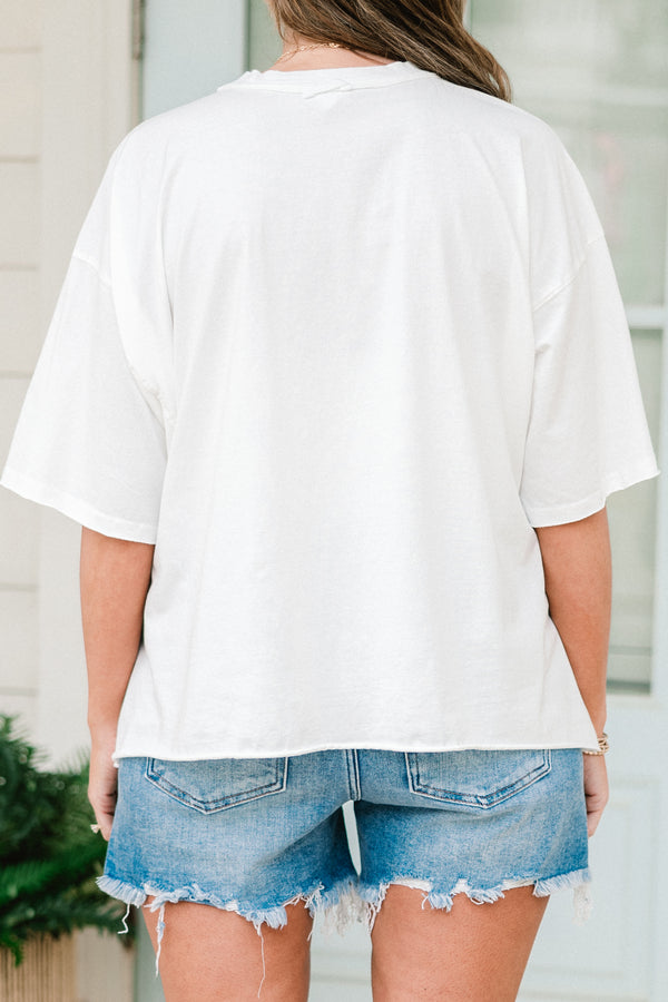 Plus Size white vintage wash tee with an American flag and blue bow graphic and unfinished hems.