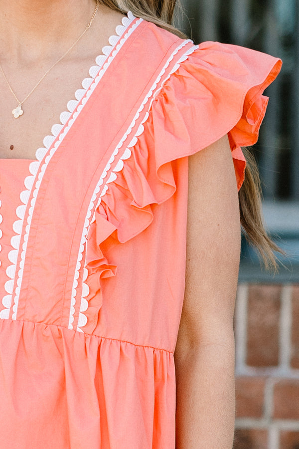 Plus Size coral peplum babydoll top with flutter sleeves and white ric rac trim.