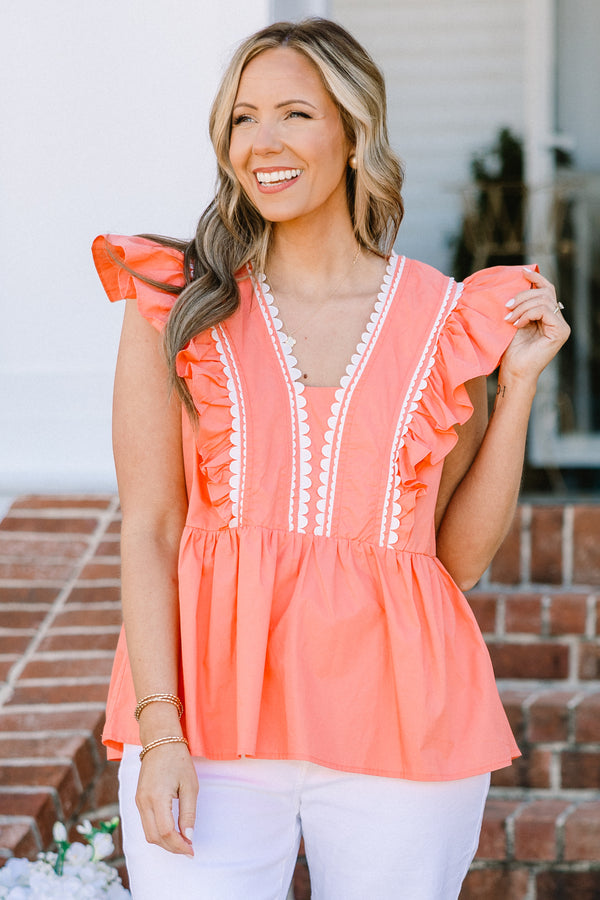 Plus Size coral peplum babydoll top with flutter sleeves and white ric rac trim.