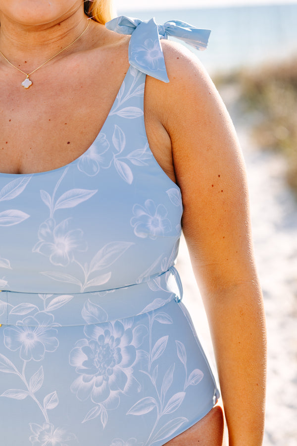 Chic Soul plus size clothing, blue and opaque white floral pattern reversible one piece swimsuit with waist band that has a gold closure and tied shoulder straps