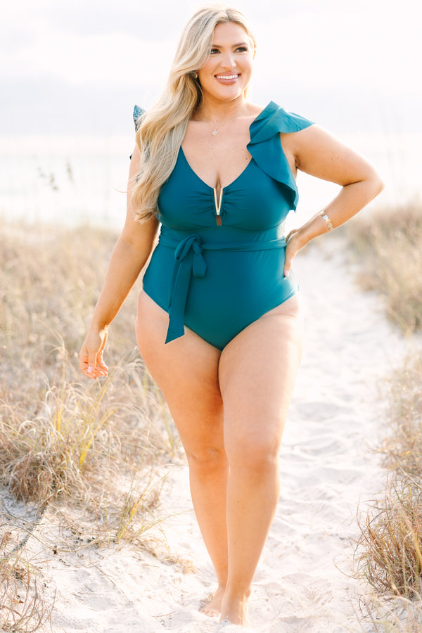 Chic Soul plus size clothing, teal one piece with flutter sleeves a belt that ties around the waist as well as a deep v-neckline that has a gold v detail along the v-neckline 